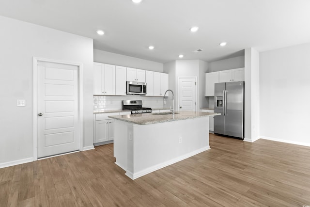 kitchen featuring a center island with sink, white cabinetry, sink, and stainless steel appliances