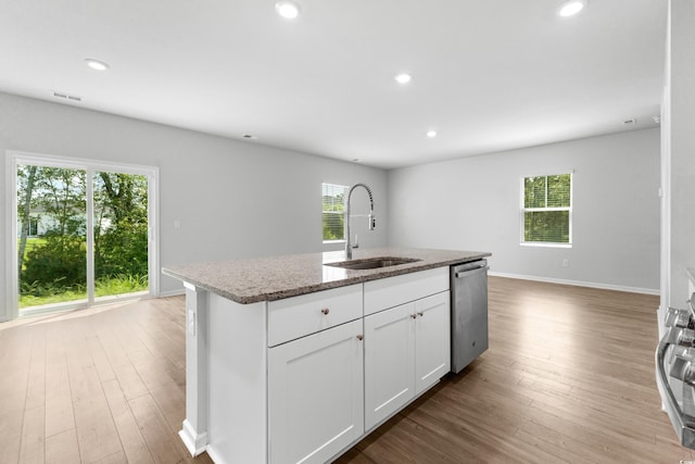 kitchen featuring an island with sink, appliances with stainless steel finishes, plenty of natural light, and sink