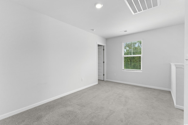 spare room with light colored carpet