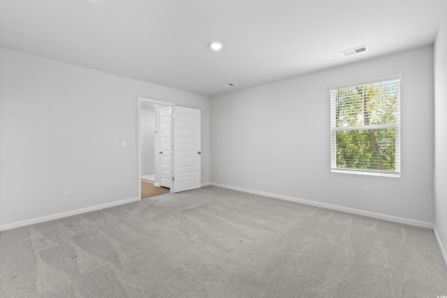 unfurnished bedroom featuring light colored carpet