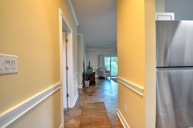 corridor with light tile patterned floors and crown molding