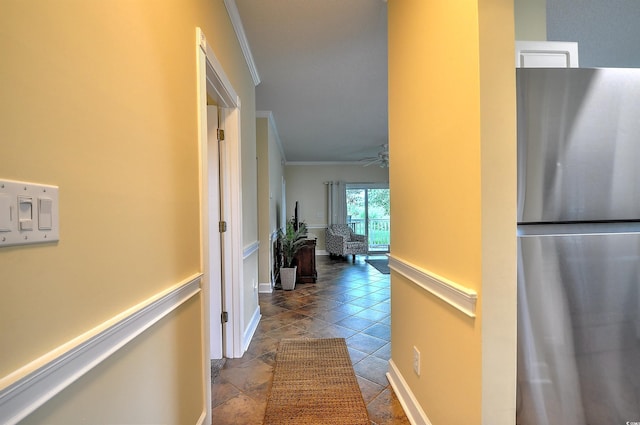 hallway with crown molding and baseboards