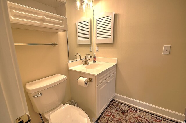 bathroom featuring toilet and vanity