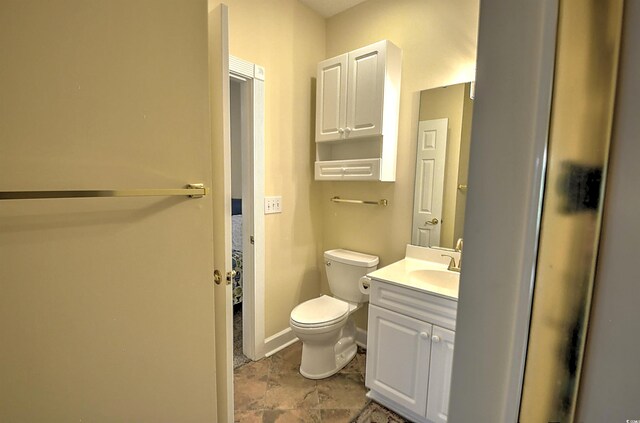 bathroom featuring tile patterned floors, vanity, and toilet