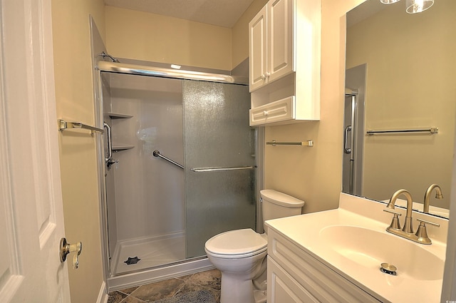 full bathroom with toilet, a stall shower, and vanity