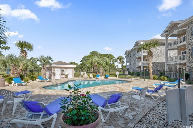 4709 Wild Iris Dr Unit 104, Myrtle Beach, SC 29577 - community pool featuring fence and a patio