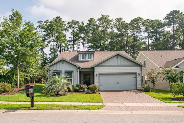 view of front of house with a garage and a front lawn