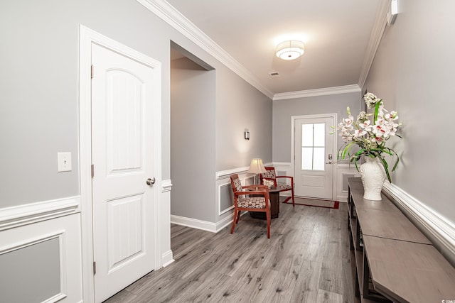 interior space with crown molding and light wood-type flooring