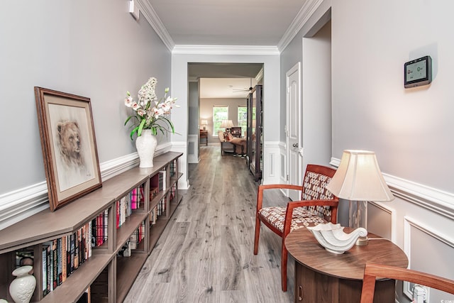 hall with crown molding and light hardwood / wood-style floors