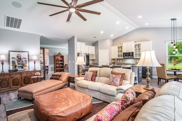 living room with wood-type flooring, lofted ceiling with beams, and ceiling fan