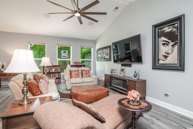 living room with high vaulted ceiling, hardwood / wood-style floors, and ceiling fan