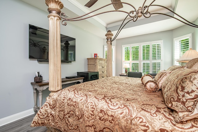 bedroom with crown molding and dark hardwood / wood-style flooring