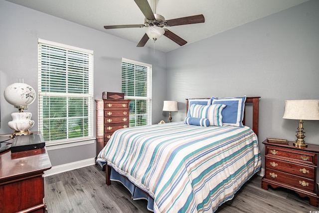 bedroom with ceiling fan and hardwood / wood-style floors