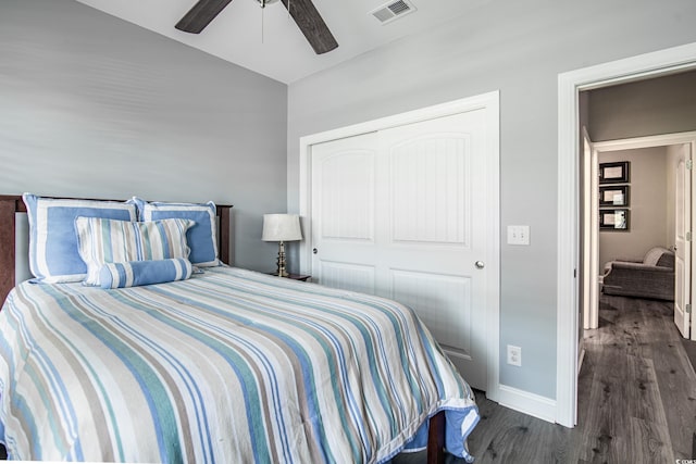 bedroom with lofted ceiling, dark hardwood / wood-style floors, ceiling fan, and a closet