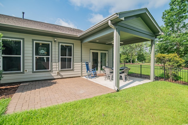 rear view of property with french doors, a yard, and a patio