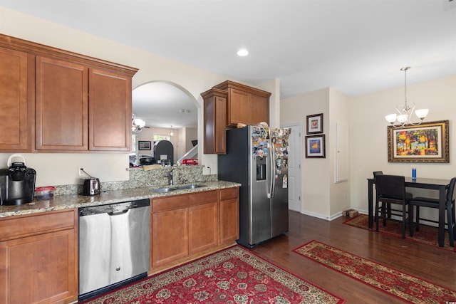 444 Papyrus Cir Unit 444, Little River, SC 29566 - kitchen with appliances with stainless steel finishes, dark wood finished floors, a chandelier, brown cabinets, and light stone countertops
