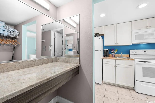 bathroom with tile patterned flooring and vanity