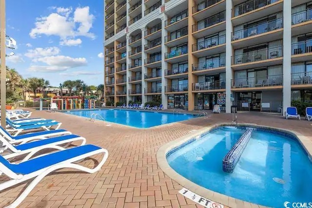 view of swimming pool with a patio area