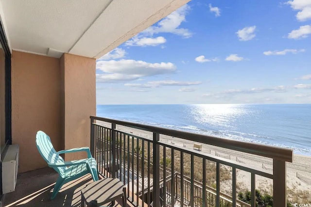 balcony featuring a water view and a view of the beach