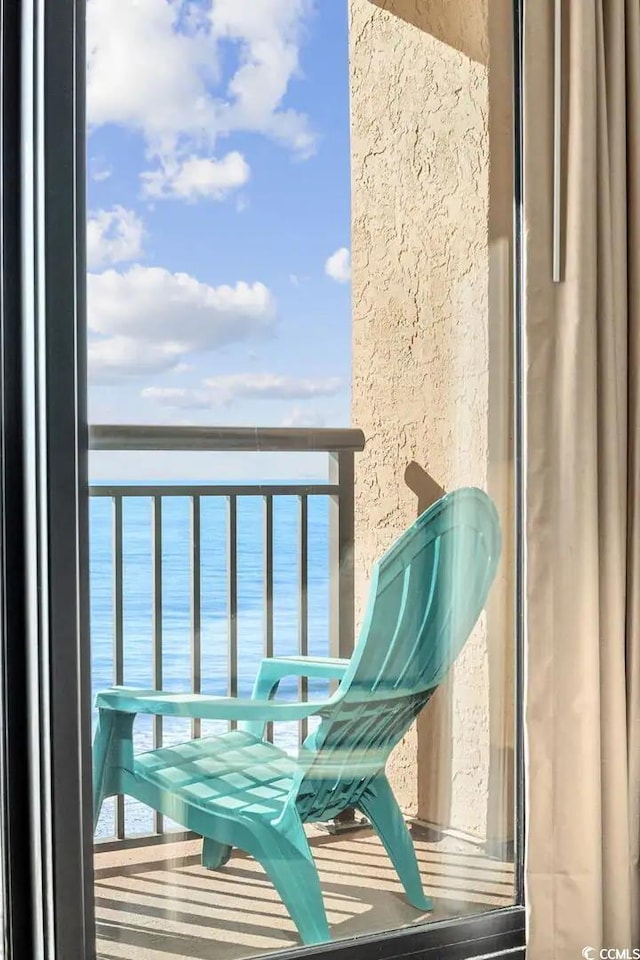 balcony featuring a water view