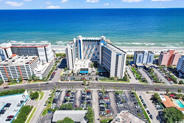 aerial view with a water view and a beach view