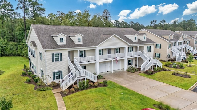 view of front of property featuring a front yard and a garage