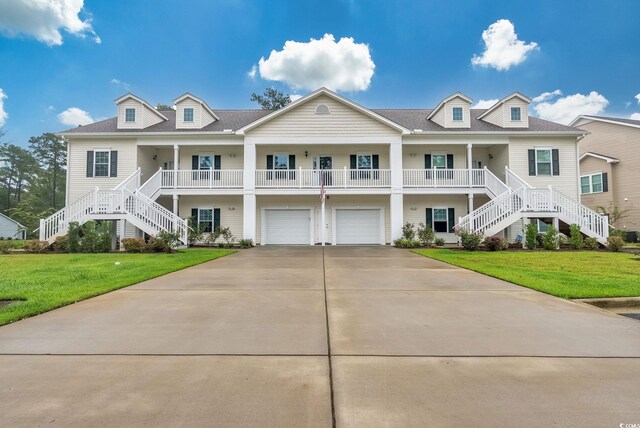 view of front of home featuring a porch, a garage, and a front lawn