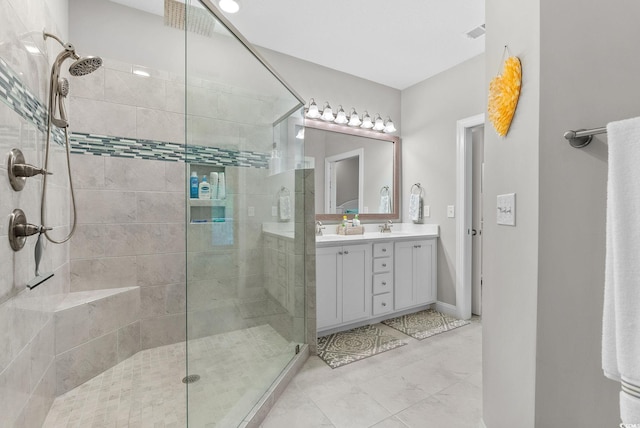 bathroom featuring tile patterned floors, double sink vanity, and a shower with door