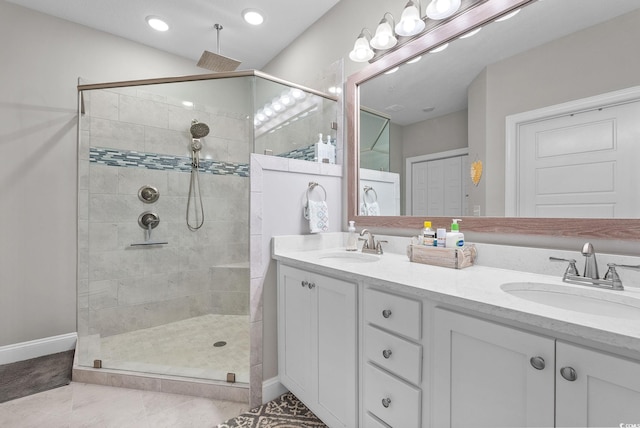 bathroom featuring a shower with shower door, tile patterned floors, and double vanity