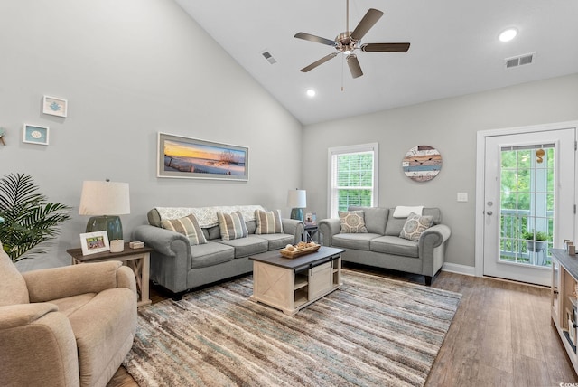 living room with ceiling fan, high vaulted ceiling, and hardwood / wood-style floors