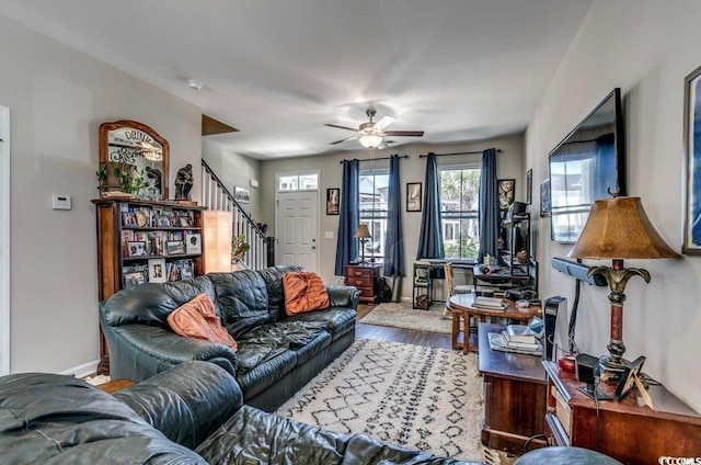 living room featuring wood-type flooring and ceiling fan