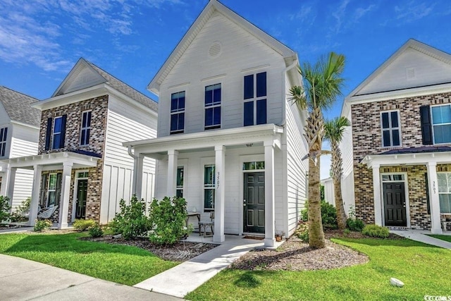 3507 Fountain Ln, Myrtle Beach, SC 29577 - view of front of property with a front lawn, brick siding, and covered porch