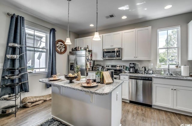 3507 Fountain Ln, Myrtle Beach, SC 29577 - kitchen with a center island, visible vents, light wood-style floors, and appliances with stainless steel finishes