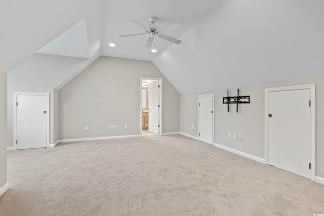 unfurnished bedroom featuring ceiling fan, ensuite bathroom, and light carpet