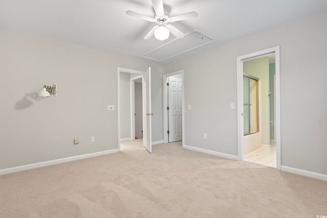 unfurnished bedroom with ceiling fan, light colored carpet, and ensuite bath