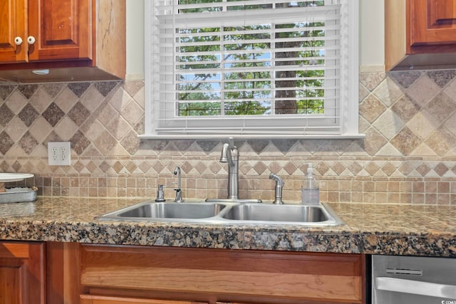 kitchen featuring tasteful backsplash and sink