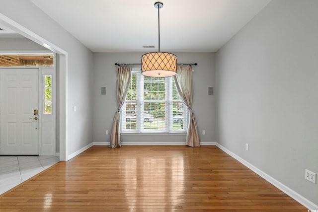 foyer featuring a wealth of natural light and light hardwood / wood-style floors