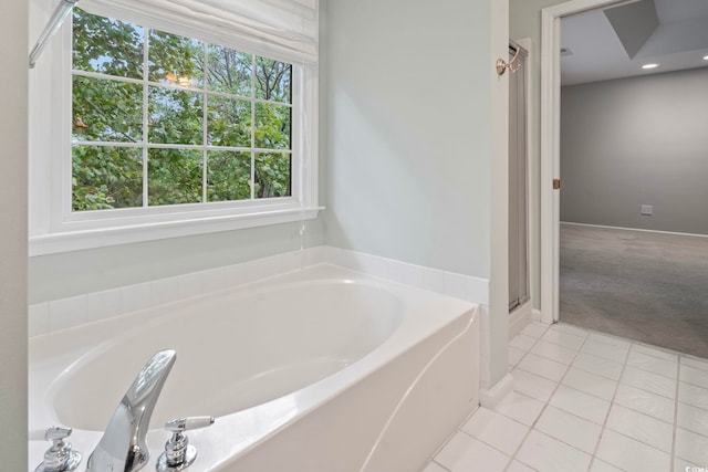 bathroom with plenty of natural light, tile patterned floors, and shower with separate bathtub