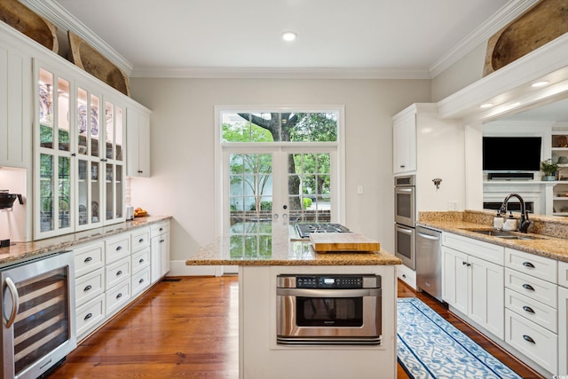 kitchen featuring wine cooler, white cabinets, stainless steel appliances, and hardwood / wood-style flooring