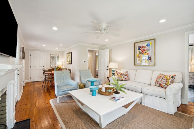 living room featuring ceiling fan, crown molding, and hardwood / wood-style flooring