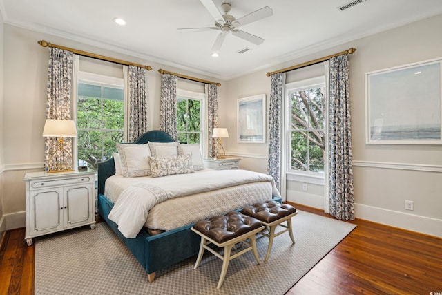 bedroom with ceiling fan, dark hardwood / wood-style flooring, and crown molding