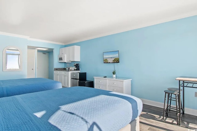 bedroom with crown molding and hardwood / wood-style floors