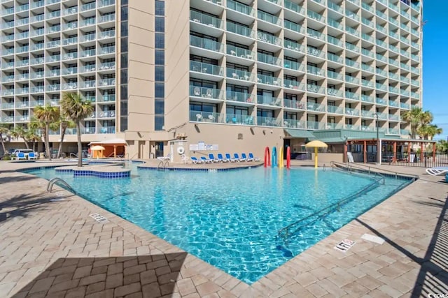 view of pool with a jacuzzi