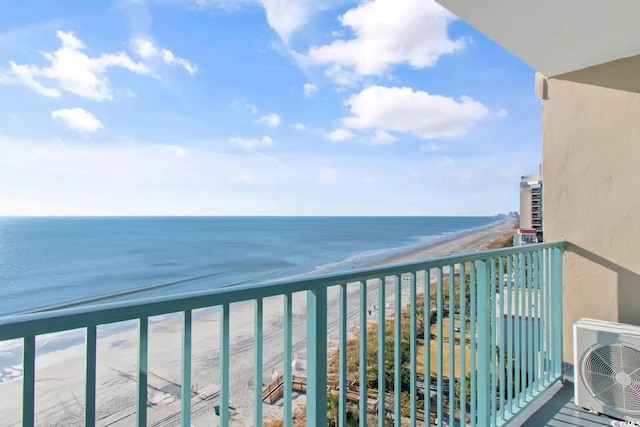 balcony featuring a beach view, a water view, and ac unit