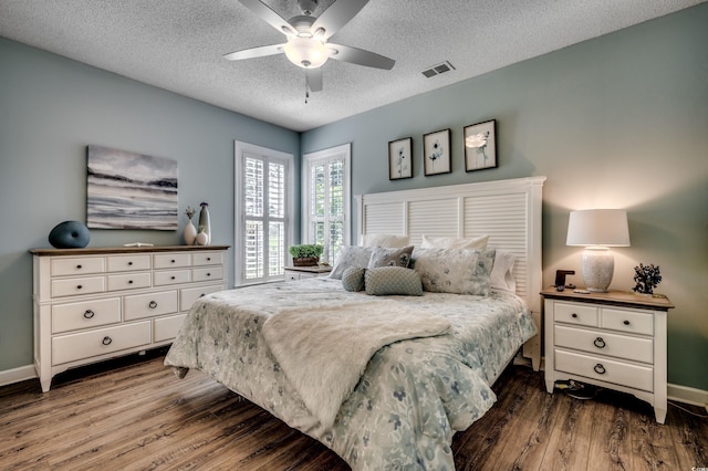 bedroom with ceiling fan, a textured ceiling, and hardwood / wood-style flooring