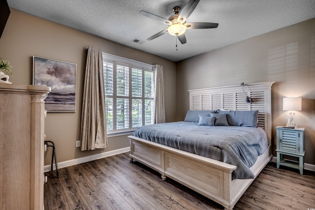 bedroom with ceiling fan, a textured ceiling, and hardwood / wood-style flooring