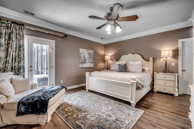 bedroom featuring ceiling fan, a textured ceiling, hardwood / wood-style flooring, and access to exterior