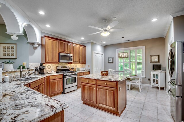 kitchen with tasteful backsplash, appliances with stainless steel finishes, light tile patterned flooring, and sink