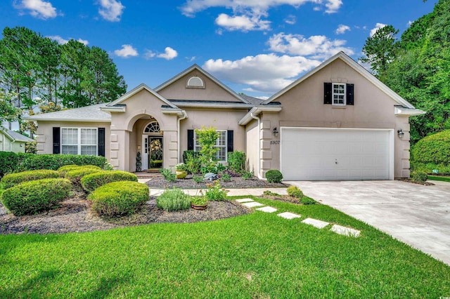 view of front of house featuring a front yard and a garage