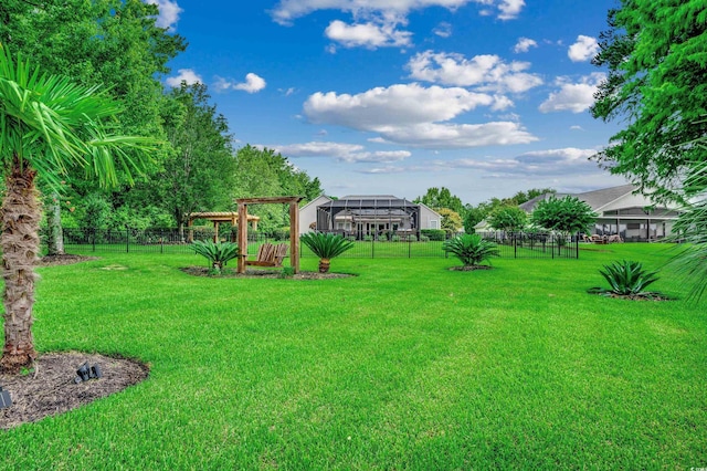 view of yard featuring a pergola and glass enclosure